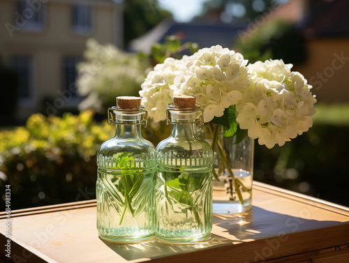 Bottle of Absinthe with Lime Slices and Flowers on a Windowsill photo