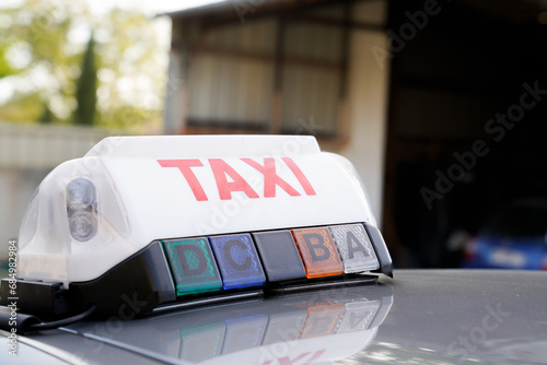 Fototapeta Naklejka Na Ścianę i Meble -  Taxi sign on car roof of french taxi