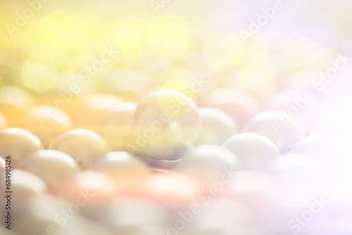 Abstract background with lens flare and pearls. A string of pearls. Artificial garland of pearls.