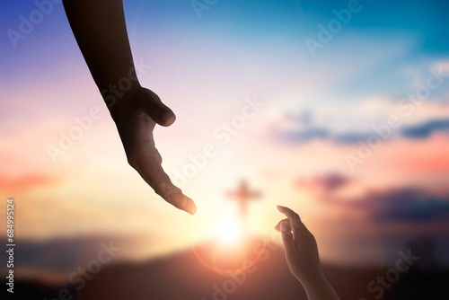 God's helping hand and cross on sunset background
 photo