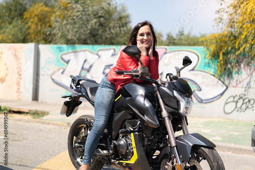 Middle aged woman with a motorcycle at outdoors