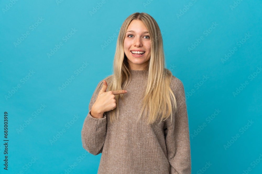 Fototapeta premium Young blonde woman isolated on blue background with surprise facial expression