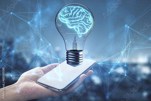 Brain in lightbulb hovering over a smartphone. Digital learning and AI concept photo