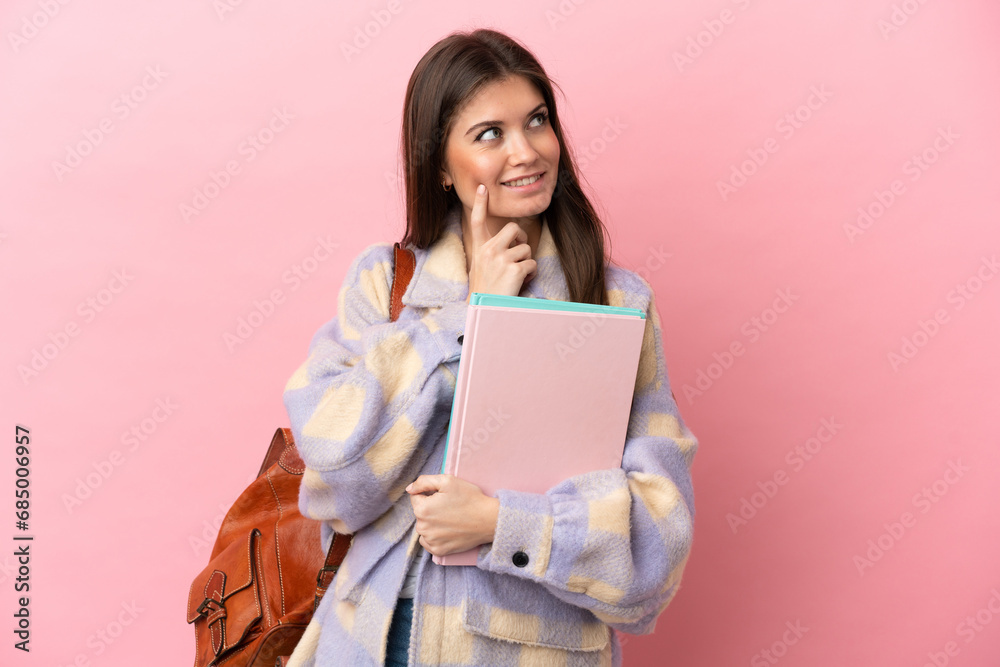 Young student woman isolated on pink background thinking an idea while looking up Young student woman isolated on pink background thinking an idea while looking up