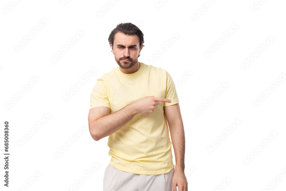 well-groomed young caucasian man with an unshaven beard and mustache against the background with copy space well-groomed young caucasian man with an unshaven beard and mustache against the background with copy space