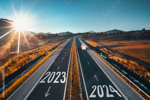 Driving on open road at beautiful sunny day to new year 2024. Aerial view photo