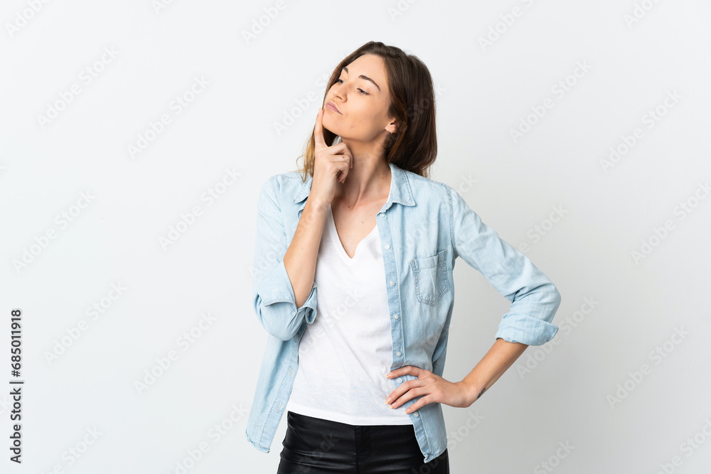 Young Ireland woman isolated on white background having doubts while looking up Young Ireland woman isolated on white background having doubts while looking up