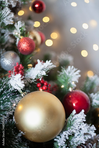 Decorated Christmas, New year room with beautiful snow-covered fir tree and golden ball on lights background