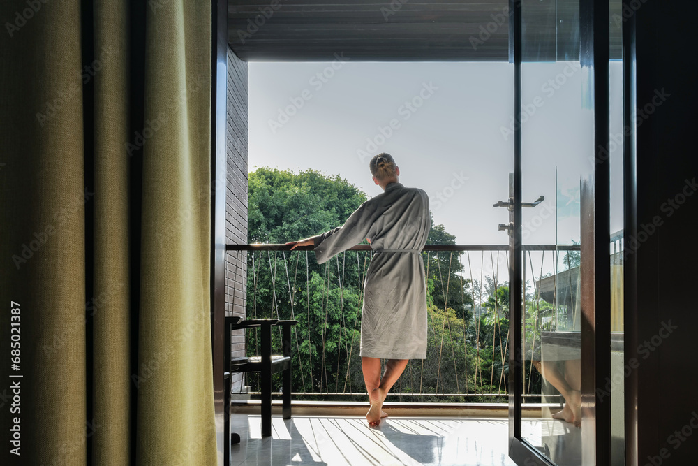 Woman standing on the balcony