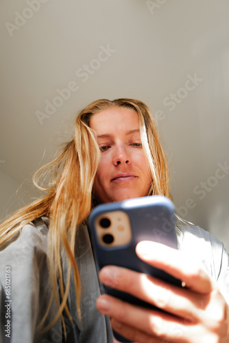 Low angle view on woman using her mobile phone
