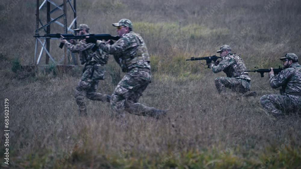 Two Soldiers Run Forward While The Other Two Crouch With Rifles Pointed Forward Two Soldiers Run Forward While The Other Two Crouch With Rifles Pointed Forward