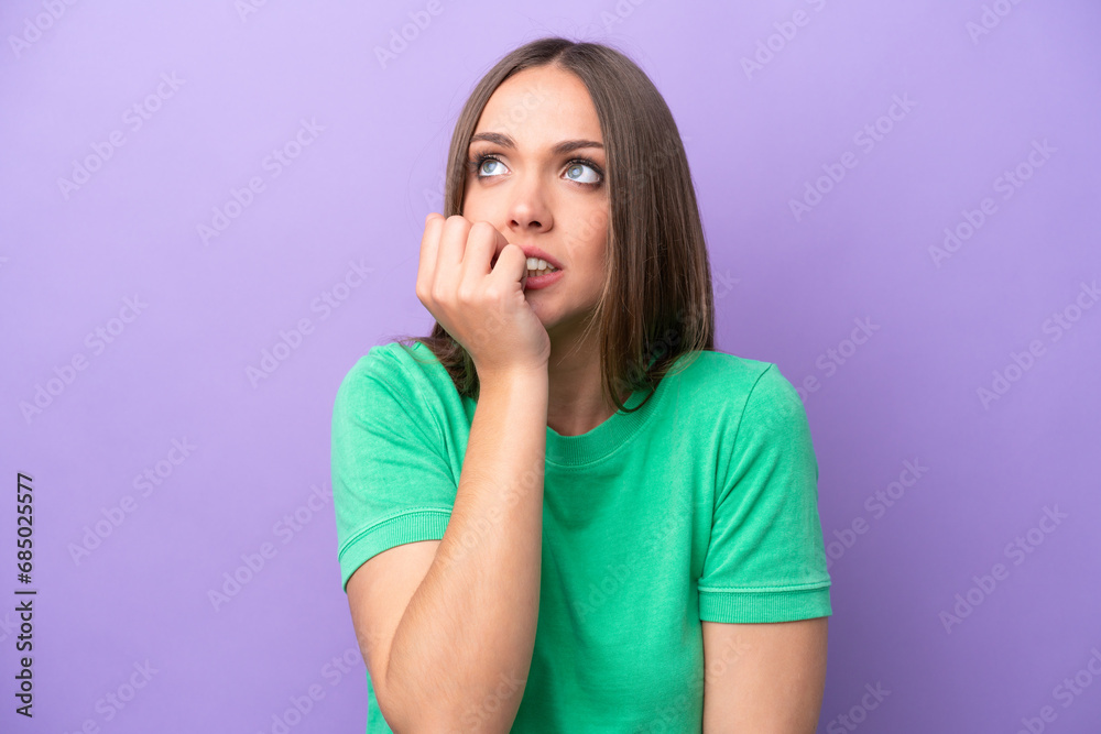 Young caucasian woman isolated on purple background is a little bit nervous Young caucasian woman isolated on purple background is a little bit nervous