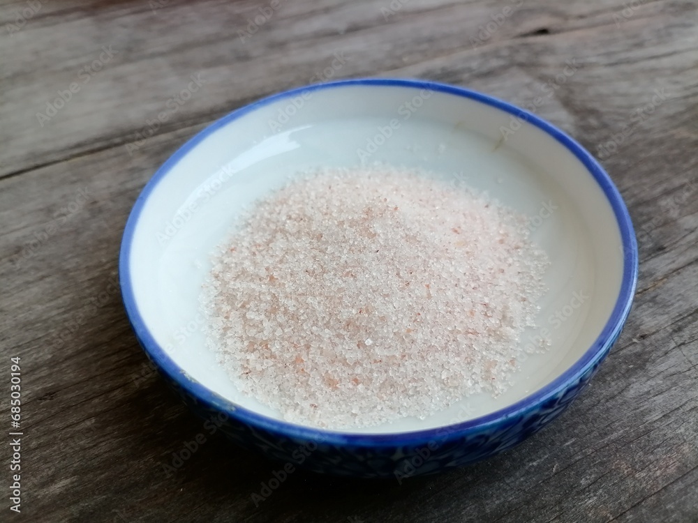 Himalayan pink salt on table wood background Himalayan pink salt on table wood background