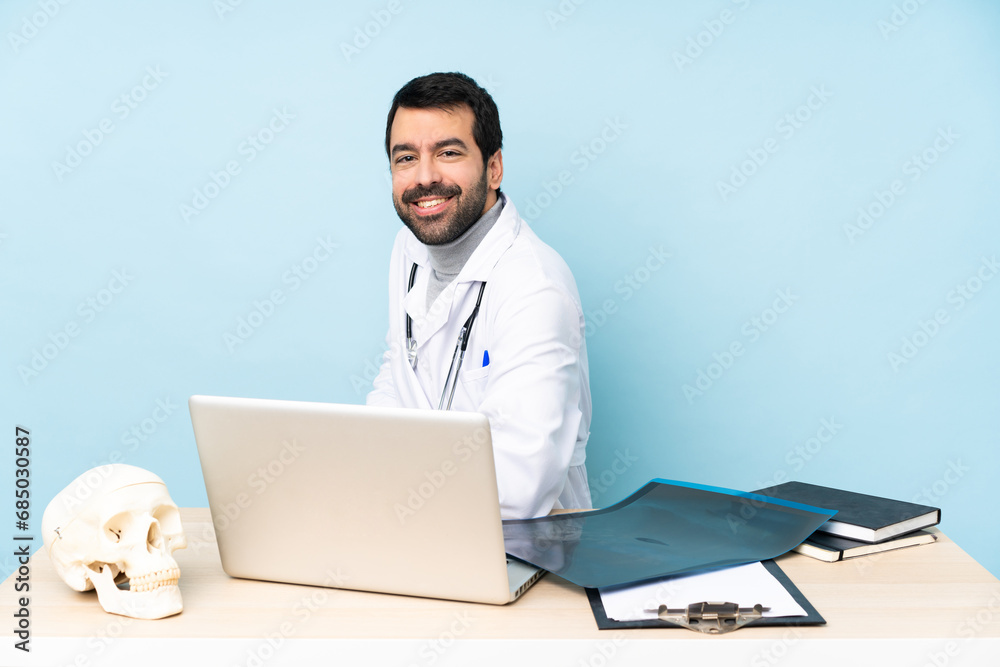 Professional traumatologist in workplace with arms crossed and looking forward Professional traumatologist in workplace with arms crossed and looking forward