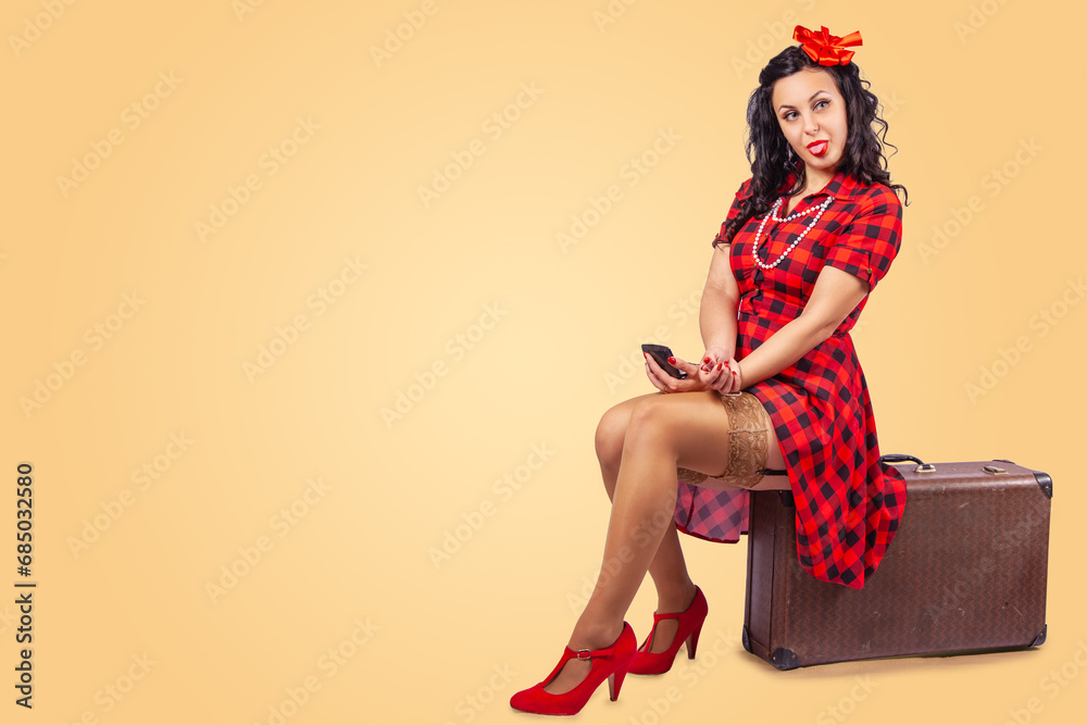 happy young pinup woman sitting on a chair in studio