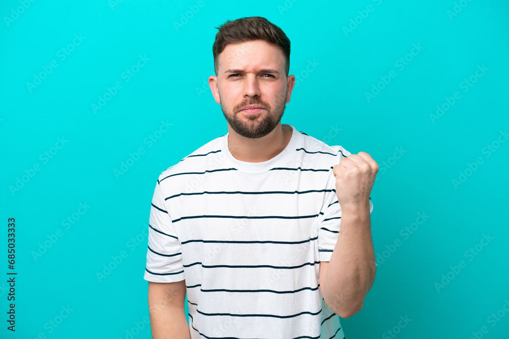 Young caucasian man isolated on blue background with unhappy expression Young caucasian man isolated on blue background with unhappy expression