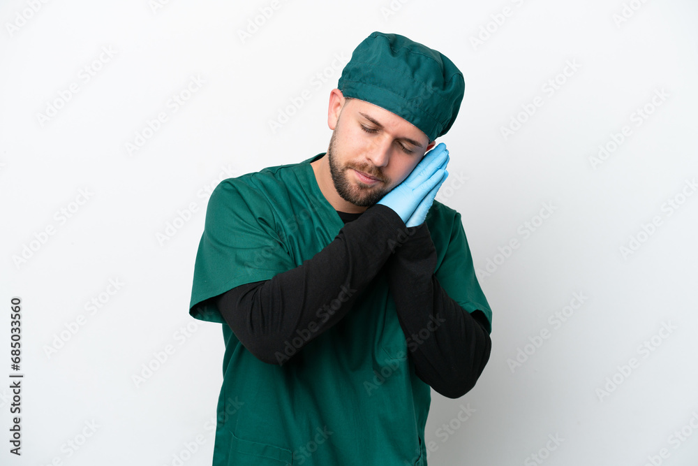 Surgeon in green uniform isolated on white background making sleep gesture in dorable expression Surgeon in green uniform isolated on white background making sleep gesture in dorable expression