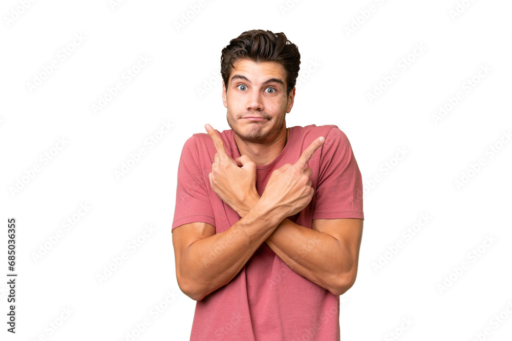 Young handsome caucasian man over isolated background pointing to the laterals having doubts