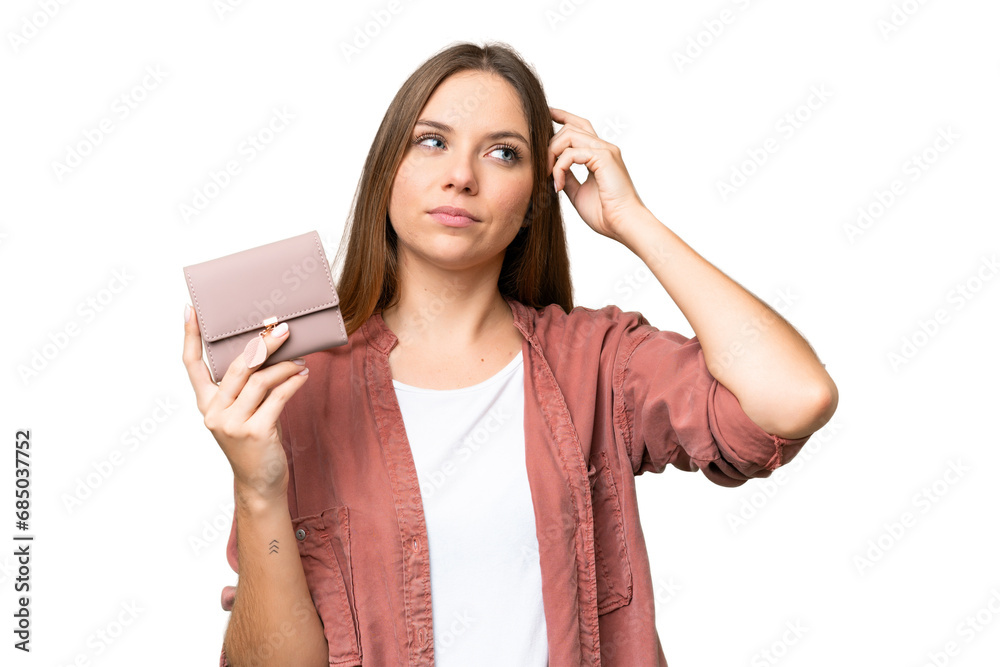 Young blonde woman holding a wallet over isolated chroma key background having doubts and with confuse face expression