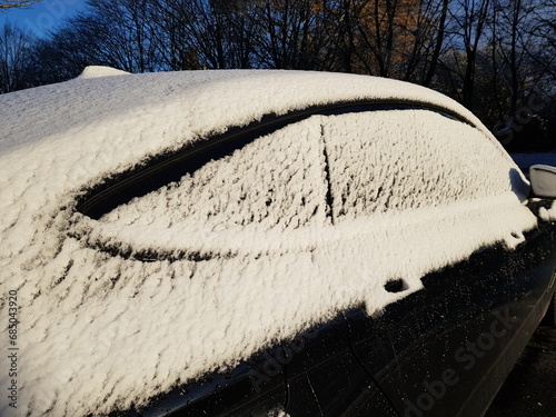 Onset of winter on November 28, 2023 in Hannover, Germany. Snowy cars and slippery roads. photo