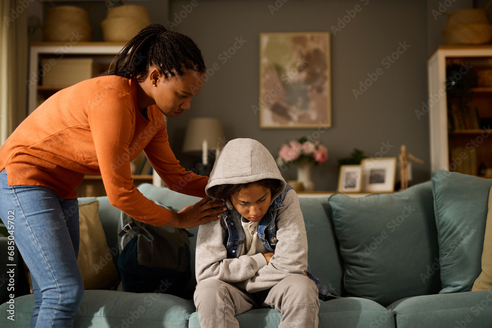 Mother comforting her son at home- teenage problems Mother comforting her son at home- teenage problems