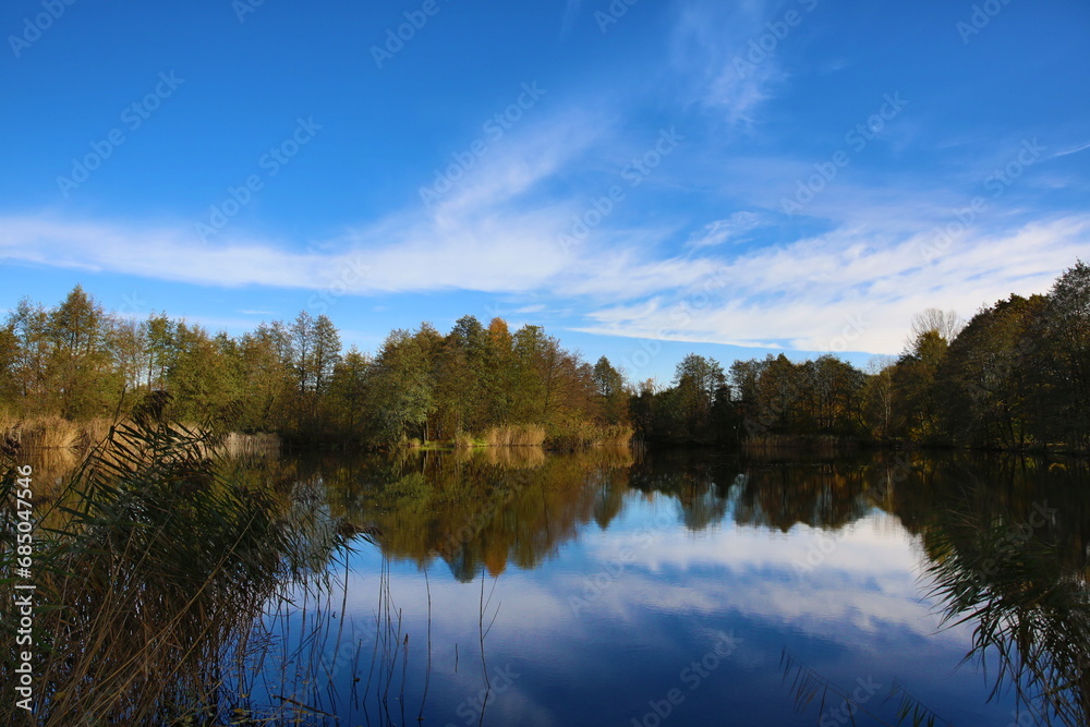 Beautiful autumn over a small lake on a sunny warm day