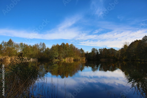 Beautiful autumn over a small lake on a sunny warm day
