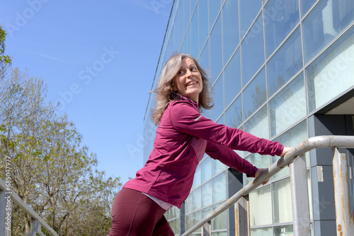 Tired, happy and elderly woman doing outdoor exercise in the city. Retirement health, fitness. Healthy exercise with training for older seniors