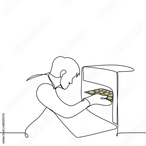 man with an open oven takes out or puts in a baking tray with cookies  - one line art vector. concept home cooking cookies