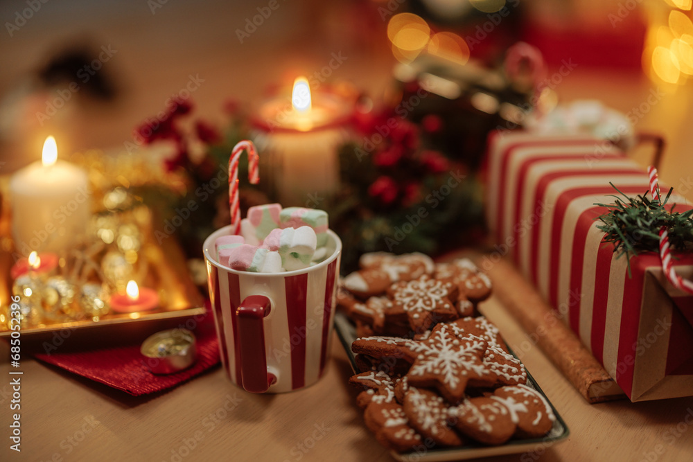 Christmas cookies, hot cocoa and present on the table