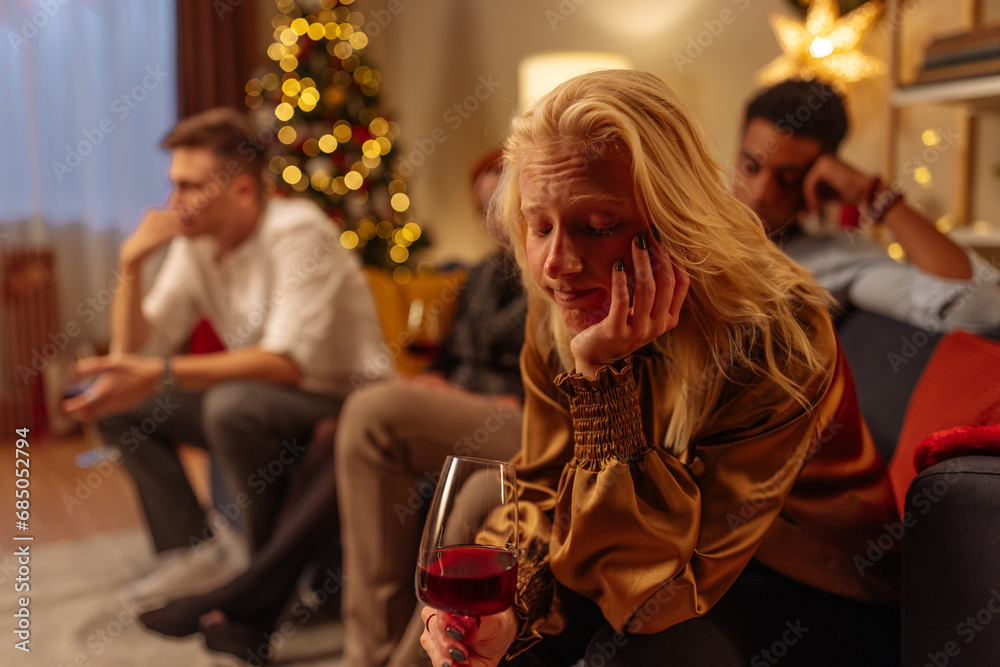 Albino girl sitting, holding wine and looking sad during Christmas holidays Albino girl sitting, holding wine and looking sad during Christmas holidays
