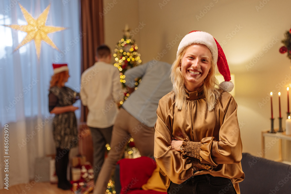 Albino woman looking at the camera while her friends decorate the Christmas tree
