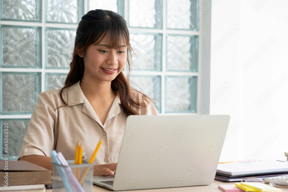 Busineswoman or employee working on laptop and papers. Busineswoman or employee working on laptop and papers.