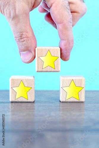 Wooden cubes with icons stars.male hand