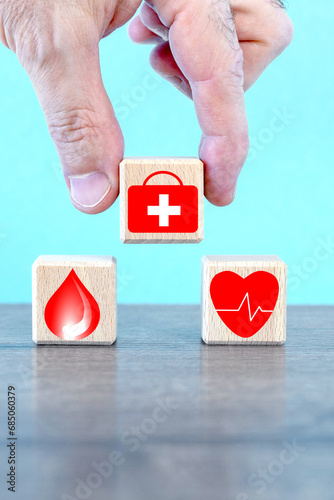 hand holding wood cube with healthcare medical icons