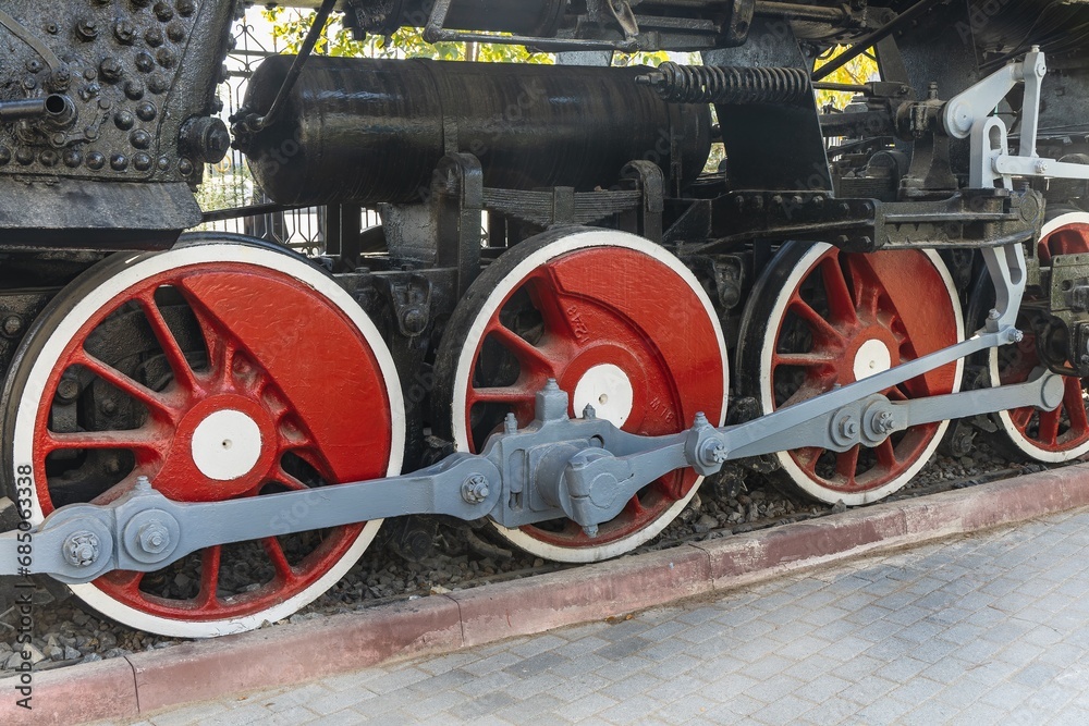 Mechanical wheels of a transport steam locomotive on rails