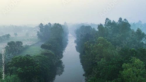 Aerial view of a village nearby a river in a foggy winter morning. Nature, travel, and rural life. Biking, cycling, hiking, travel, vacation photo