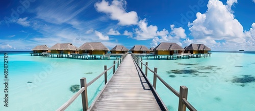Exotic summer getaway stunning Maldives with tropical landscapes wooden bridge water villas and beautiful island beaches copy space image