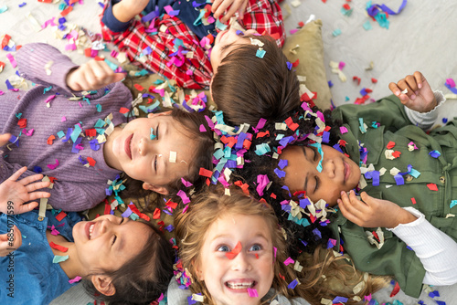 Portrait happy friend school girl children student, kid, child having fun activity play party, festive and event celebration with colorful confetti, birthday, new year, children day at school.