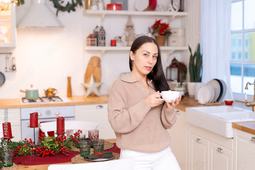 Concept festive Christmas atmosphere, cute woman drinking tea or coffee