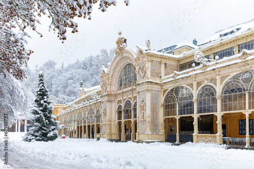 Snow-covered main colonnade with Christmas tree in spa town Marianske Lazne (Marienbad) - Czech Republic, Europe