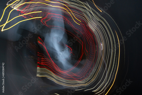Abstract light patterns from cars at night using intentional camera movement photo
