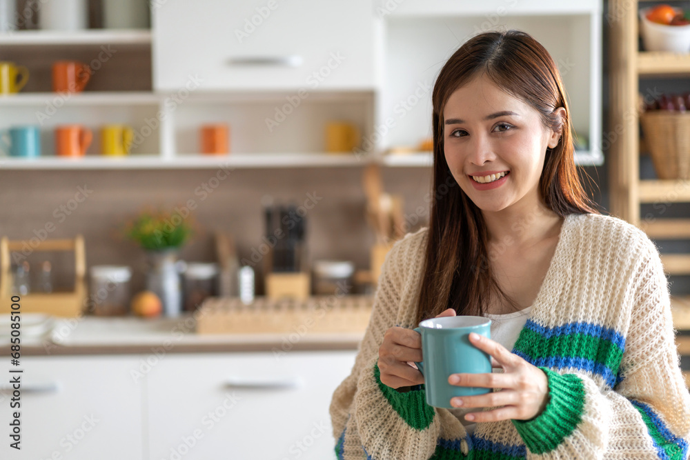 Portrait of smiling happy cheerful beauty pretty asian woman relaxing drinking and looking at cup of hot coffee or tea.Girl felling enjoy having breakfast in holiday morning vacation on bed at home. Portrait of smiling happy cheerful beauty pretty asian woman relaxing drinking and looking at cup of hot coffee or tea.Girl felling enjoy having breakfast in holiday morning vacation on bed at home.