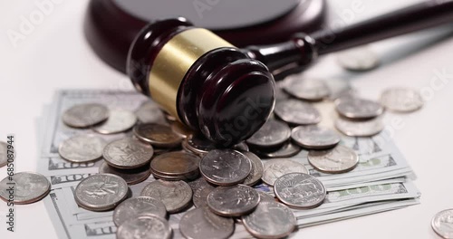 Judge gavel with cash and coins on table. Tax evasion concept photo