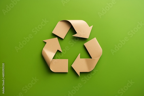 Recycling symbol cut out of kraft paper on green background, top view. Generated AI