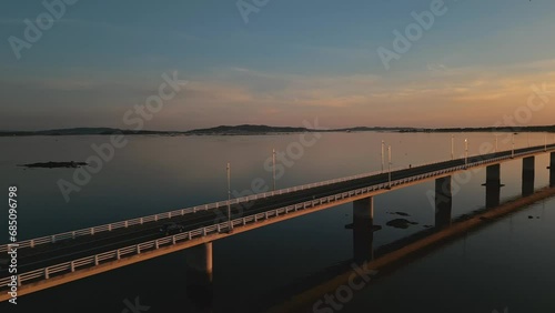 Wallpaper Mural Establishing aerial view of a cars driving on a long sea bridge at sunset with a beautiful golden color reflect of the sea. Concept of transportation and travel in Spain Arosa Island Bridge Torontodigital.ca