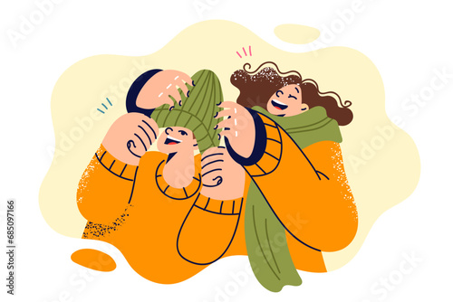 Laughing children don winter hats and scarves as head out for sunday walk or trip to ski resort