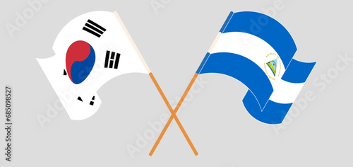Crossed and waving flags of South Korea and Nicaragua