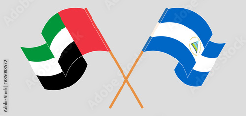 Crossed and waving flags of the United Arab Emirates and Nicaragua