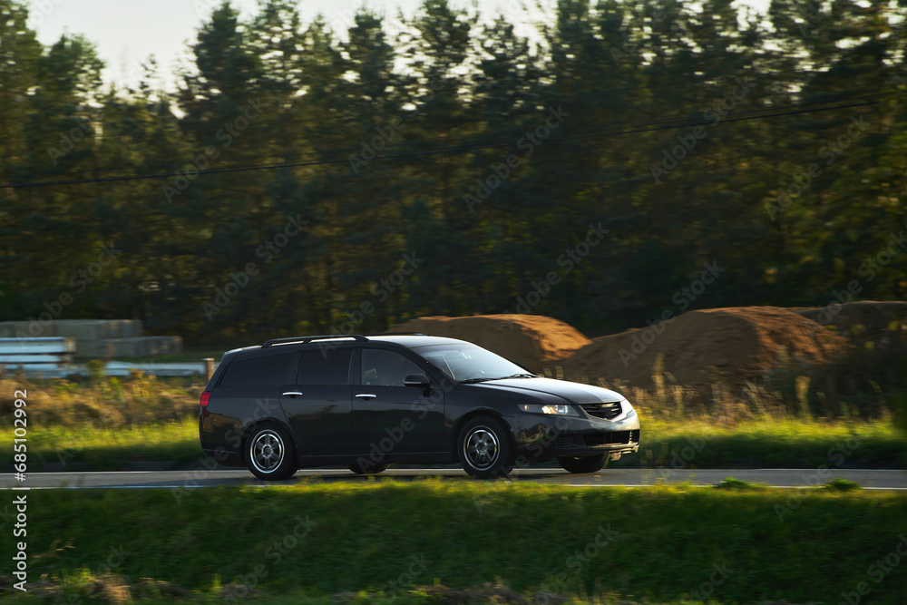 A New and Modern Station Wagon Car on the Highway. A Spacious and Elegant Vehicle for Family and Sport. How to Combine Practicality and Style in a Car. A Combi Car with a Powerful Engine.